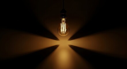 Vintage light bulb glowing in dark room, idea and creativity concept, light and shadow