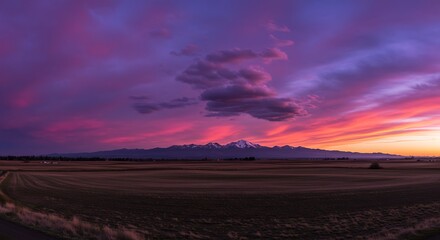 Vibrant sunset over mountain range with colorful sky and dramatic clouds