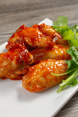 A view of a plate of Asian spicy glaze wings.