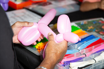 A view of a person making balloon animals.