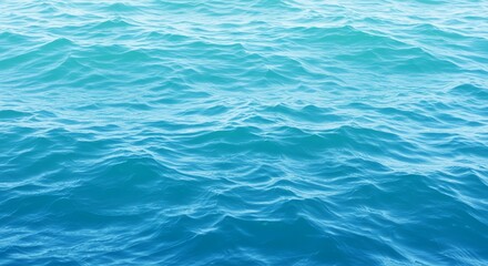 Obraz premium Close-up view of rippling turquoise ocean water with gentle waves under natural light.