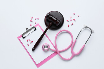 Judge gavel, clipboard, pills and stethoscope on white background. Concept of health care reform