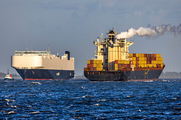 Germany, Elbe River Estuary. Ships passing each other (car carrier and container ship) at the mouth of the Elbe near Cuxhaven