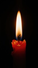 A glowing red candle burns brightly against a pitch-black background, its warm flame casting soft light — evoking calm, romance, or solemnity in minimalist still life.