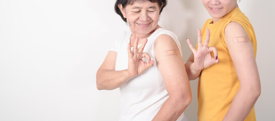 Adult and Elderly Woman with bandage after received vaccine. Vaccination and Immunization for...
