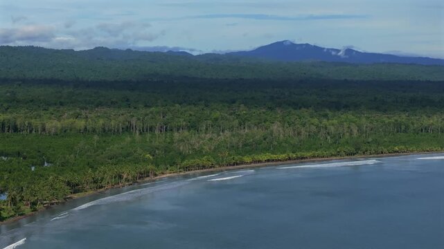 Wewak sea harbour view Wewak Hill Cape Wom Dogreto aerial drone Papua New Guinea Pacific Ocean pristine remote tropical beach coastline sunny dry season blue sky morning mountain pass backwards pan up