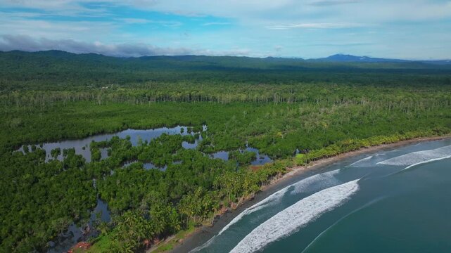 Wewak waves sea harbour view Wewak Hill Cape Wom Dogreto aerial drone Papua New Guinea Pacific Ocean pristine remote tropical beach coastline sunny dry season blue sky morning mountains backwards