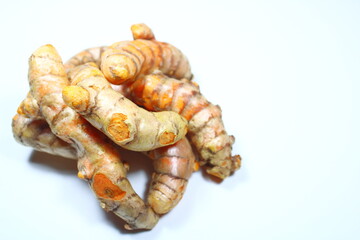Fresh raw turmeric rhizomes isolated on a pure white background