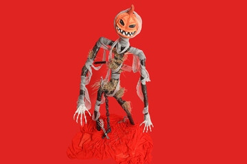 Spooky Halloween monster in bandages on red background