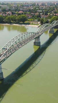 Aerial vertical shot of Hungary&rsquo;s M&aacute;ria Val&eacute;ria Bridge, capturing the historic structure and scenic river views