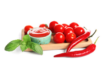 Bowl of tasty tomato sauce with basil leaves and chili peppers on white background