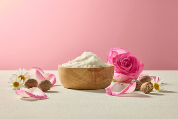 Close-up composition of shea butter chunks with roses and chamomile accents. Neutral beige tone background for beauty, wellness and cosmetic advertising visuals.