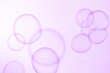 Beautiful Clear Purple Soap Bubbles Floating in The Air. Celebration Festive Backdrop. Freshness Soap Suds Bubbles Water. Purple and White Gradient Textured.	
