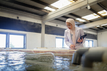 Veterinarian Inspecting Fish Health in Modern Aquaculture Hatchery