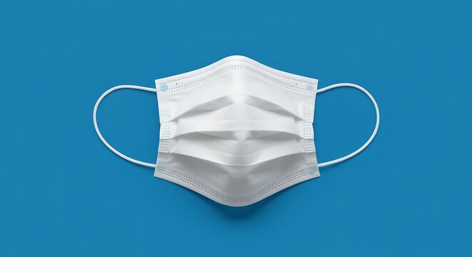 White medical face mask on blue background for health protection concept
