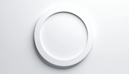 An overhead shot of a simple, white, circular frame casting a subtle shadow