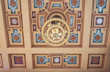 Chandelier on the ceiling. Union Station Kansas City. Chandelier hang from the glorious ceiling in Grand Hall. Architecture background. Architectural detail in grand hall train station in Kansas city