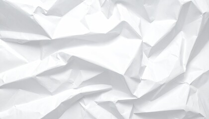 Close-up of crumpled white paper with sharp folds creating shadows and light