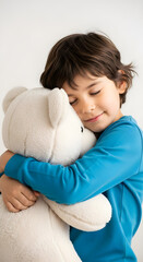 Fototapeta premium Peaceful child embracing a soft teddy bear with eyes closed.