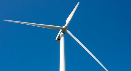 Wind turbine against clear blue sky generating renewable energy