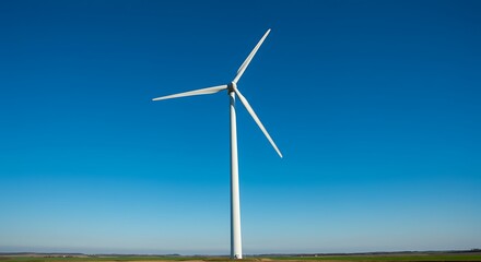 Wind turbine generating renewable energy against blue sky