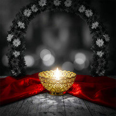 Golden Candle in Ornate Bowl with Floral Arch and Red Fabric