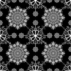 Intricate black and white mandala pattern featuring floral designs and geometric shapes, creating harmonious and elegant visual effect