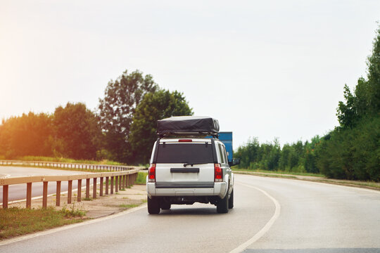 Fototapeta Family vehicle with roof tent on scenic road trip