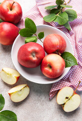 Fresh red apples in white bowl on table