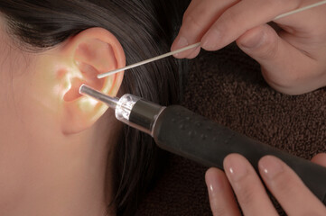 close up of a woman applying mascara