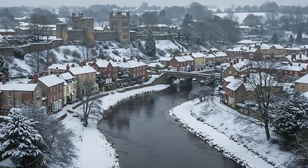 Obraz premium Snow covered townscape with river and historic buildings aerial view