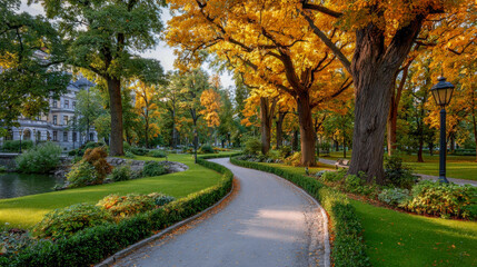 Naklejka premium Scenic park pathway surrounded by vibrant autumn trees, lush greenery, and a tranquil pond, creating a serene atmosphere for leisurely strolls and relaxation