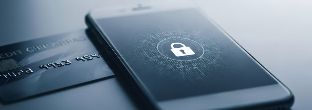 Smartphone with padlock icon on screen near credit card. Personal data protection and cyber security concept.