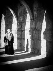 Head Cover Woman Silhouetted by Dramatic Shadows On Ancient Stone 