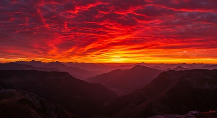 Fototapeta premium Spectacular fiery sunset over mountain range silhouette dramatic sky view