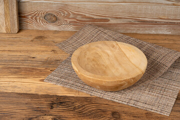 Empty wood bowl on table, plate on wooden table and tablecloth, light rustic dish mockup