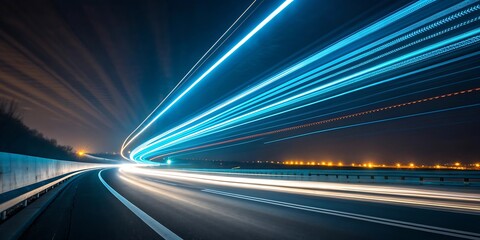 Blurring blue and white light trails streaking across a dark highway at night conveying speed and motion