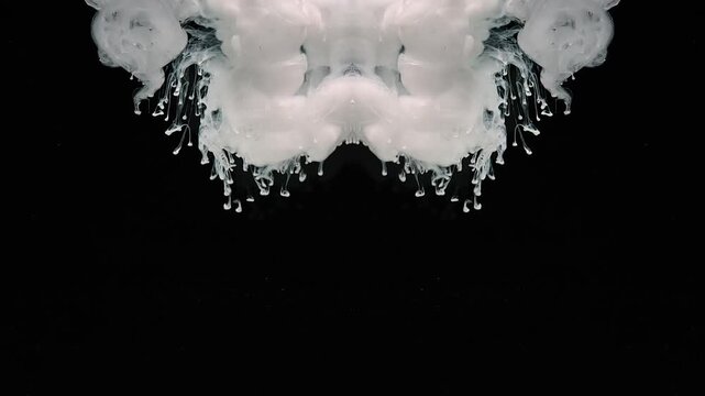 Mysterious and sinister abstract background made of moving white watercolor ink. The concept of black magic. The thick smoke creates a sense of chaos and confusion. The scene is dark and ominous