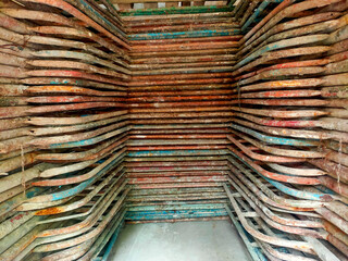 Rows of metal pipes stacked symmetrically in a narrow space, creating an industrial pattern. Perfect for construction, architecture, or industrial themes.