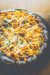 Tandoori Chicken Pizza Charcoal base, roasted pepper sauce, mozzarella, tandoori chicken, red onion, jalapeno, spicy mayo