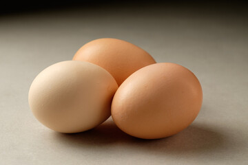 Fresh eggs resting gently on a smooth surface, showcasing natural colors