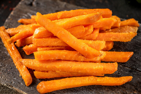 Closeup of sweet potato fries on board
