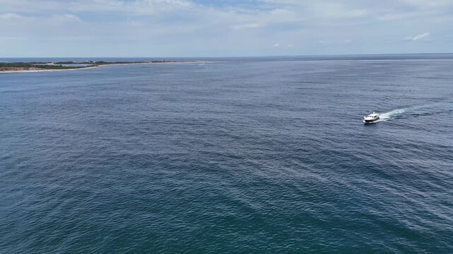 Aerial view of Block Island's dramatic coastline, where the azure sea meets the rugged cliffs and the horizon stretches endlessly, New Shoreham, Rhode Island, United States.