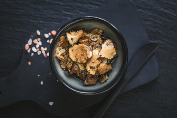 Rustic still life with truffles, truffle oil and salt on a wooden table, showcasing gourmet ingredients and culinary tools