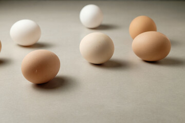 Colorful eggs scattered on a neutral surface create a serene display