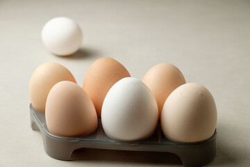 Fresh eggs displayed artistically on a gray tray in soft morning light