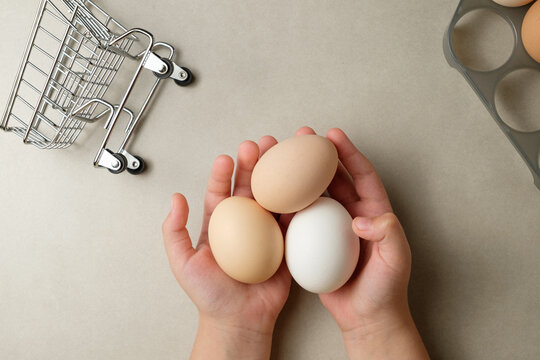 Exploring eggs: a child's hands cradling nature's treasures in a kitchen