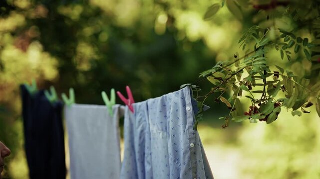 Clothes hang on clothesline and dry in backyard after washing	