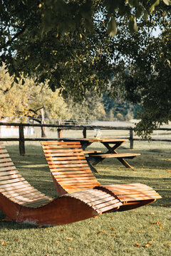 Wooden lounge chair in garden. Beautiful oudoor furniture