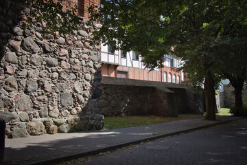 A stone wall with a stone bench in front of it